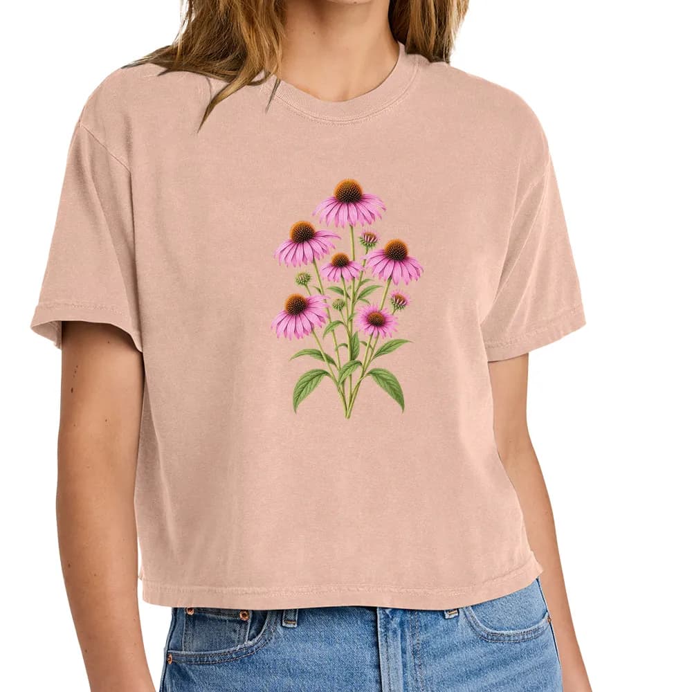 Front view of a peach-colored tee with a purple coneflower botanical print. Product visualization.